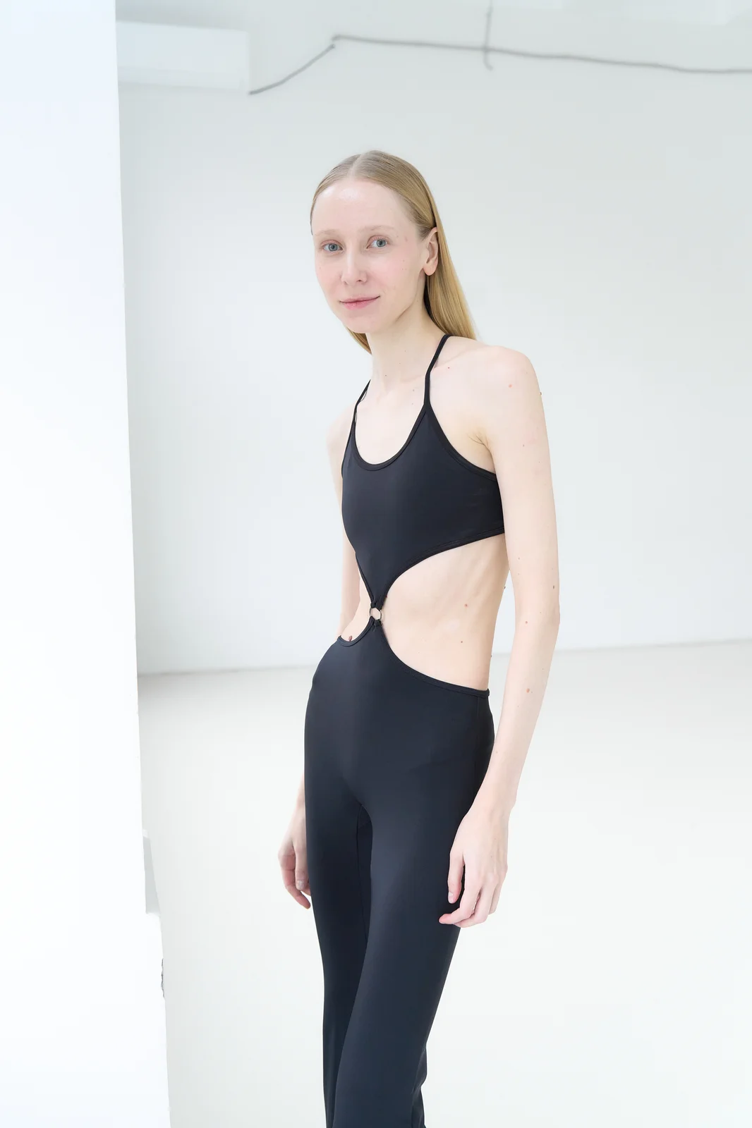 Model with her torso turned about three-quarters to the camera, looking at the lens